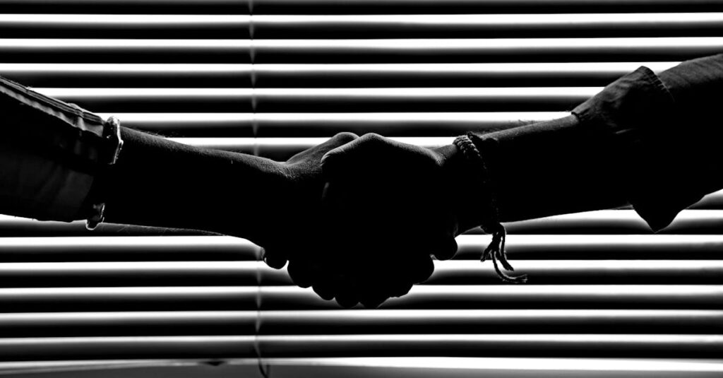 pexels-photo-814544-814544 Silhouette of two people shaking hands symbolizing partnership and trust.